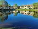 Scenic pond reflecting the surrounding buildings, creating a serene and picturesque view at 212 Triano Cir # 212, Venice, FL 34292