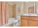 Well-lit bathroom equipped with a shower-tub combo, toilet, and a vanity with ample storage space at 2150 Snapdragon Ln, Venice, FL 34292