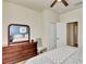 Bedroom featuring a ceiling fan, neutral walls, and a dresser with a large mirror at 2150 Snapdragon Ln, Venice, FL 34292