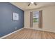Bedroom featuring hard wood floors, neutral paint, and a large window at 2150 Snapdragon Ln, Venice, FL 34292