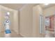 Inviting foyer featuring tile flooring, neutral walls, decorative window over door, and access to other rooms at 2150 Snapdragon Ln, Venice, FL 34292