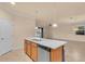 Open kitchen featuring an island with a stainless steel dishwasher and sink, white countertops and stainless steel appliances at 2150 Snapdragon Ln, Venice, FL 34292