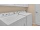 Bright laundry room with appliances and a neutral color scheme at 2150 Snapdragon Ln, Venice, FL 34292