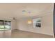 Bright living room with neutral walls, tile floors, ceiling fan, and multiple windows that offer lots of natural light at 2150 Snapdragon Ln, Venice, FL 34292