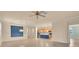 Expansive living space connecting the kitchen, with stainless steel appliances, to an open area with tile flooring at 2150 Snapdragon Ln, Venice, FL 34292