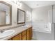 Bathroom featuring double sinks, a soaking tub, and a separate glass-enclosed shower, designed for relaxation and convenience at 2267 Yalta Ter, North Port, FL 34286