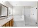 Bathroom with double sinks, a soaking tub, and a separate glass-enclosed shower, offering a spa-like experience at 2267 Yalta Ter, North Port, FL 34286