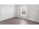 Clean, minimalist bedroom with a window, spacious closet, and neutral walls at 2267 Yalta Ter, North Port, FL 34286