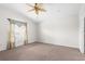 Bedroom with a ceiling fan, neutral carpeting, and a sunlit window, offering a tranquil and inviting space at 2267 Yalta Ter, North Port, FL 34286