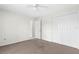 Bedroom featuring carpet flooring, an open door, a ceiling fan, and a closet at 2267 Yalta Ter, North Port, FL 34286