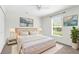 Bedroom with a large comfortable bed, lamps, and windows providing natural light at 2267 Yalta Ter, North Port, FL 34286