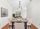 Bright dining room with seating for eight, a stylish light fixture, and decorative artwork at 2267 Yalta Ter, North Port, FL 34286