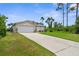 A lovely home showcasing a large driveway leading to a spacious garage and lush landscaping at 2267 Yalta Ter, North Port, FL 34286