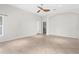 Spacious room with neutral tile flooring, a ceiling fan, and an archway leading to another room at 2267 Yalta Ter, North Port, FL 34286