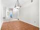 Neutral tiled space with an overhead light, offering versatility for dining or living, with doors leading to other rooms at 2267 Yalta Ter, North Port, FL 34286