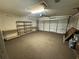 View of the spacious garage featuring shelving and an automatic door at 2267 Yalta Ter, North Port, FL 34286