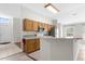 Bright kitchen area featuring wooden cabinets, a breakfast bar, and easy access to the entry and living areas at 2267 Yalta Ter, North Port, FL 34286