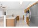 Well-lit kitchen boasts wooden cabinets, stainless steel appliances, tile flooring, and seamless connectivity to the living spaces at 2267 Yalta Ter, North Port, FL 34286