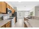 Well-lit kitchen featuring modern appliances, ample counter space, and wood cabinetry, great for cooking at 2267 Yalta Ter, North Port, FL 34286