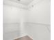 Walk-in closet featuring white walls, carpet flooring, and multiple shelves for optimal storage space at 2267 Yalta Ter, North Port, FL 34286
