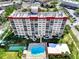 A nice aerial view of the condo building and the community pool and tennis courts below at 232 Saint Augustine Ave # 505, Venice, FL 34285