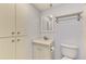 Bathroom featuring a vanity with mirror, toilet, and storage cabinet at 232 Saint Augustine Ave # 505, Venice, FL 34285