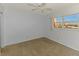 Bright bedroom featuring neutral carpet, ceiling fan, and a window with a lovely view at 232 Saint Augustine Ave # 505, Venice, FL 34285