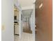 Condo entryway with tiled floors and partial view of the kitchen and living area at 232 Saint Augustine Ave # 505, Venice, FL 34285