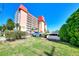 Exterior of Venice Costa Brava condo building with mature landscaping and ample parking at 232 Saint Augustine Ave # 505, Venice, FL 34285