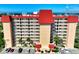 View of Venice Costa Brava featuring large balconies, a parking area and manicured landscaping at 232 Saint Augustine Ave # 505, Venice, FL 34285