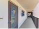 Hallway leading to condo unit E505 featuring neutral walls and secure exterior door at 232 Saint Augustine Ave # 505, Venice, FL 34285
