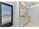 Cozy kitchen features tile flooring, white cabinetry, and essential appliances; great natural light at 232 Saint Augustine Ave # 505, Venice, FL 34285