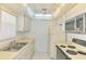 Well-lit kitchen with white cabinets, appliances, and a ceiling fan at 232 Saint Augustine Ave # 505, Venice, FL 34285