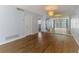 Spacious living room with wood floors, mirror wall, and overhead lighting fixture at 232 Saint Augustine Ave # 505, Venice, FL 34285