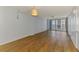 Bright living room featuring hardwood floors and sliding glass doors that lead to a balcony at 232 Saint Augustine Ave # 505, Venice, FL 34285