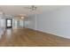 Bright living room with mirrored wall, wood floors, and access to an outdoor balcony at 232 Saint Augustine Ave # 505, Venice, FL 34285