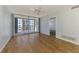 Bright living room with wood floors, ceiling fan, and sliding glass doors at 232 Saint Augustine Ave # 505, Venice, FL 34285