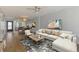 Open living area with hardwood floors, a large sofa, dining area, and access to balcony at 232 Saint Augustine Ave # 505, Venice, FL 34285