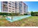 Outdoor tennis court with seating and greenery near the condo building at 232 Saint Augustine Ave # 505, Venice, FL 34285