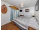 Cozy bedroom featuring hardwood floors, a comfortable bed, and unique decor creating a relaxing atmosphere at 2331 Mission Valley Blvd, Nokomis, FL 34275