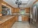 Well-lit kitchen featuring wooden cabinets, stainless steel appliances, and ample counter space at 2331 Mission Valley Blvd, Nokomis, FL 34275