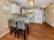 Functional kitchen with white cabinetry, modern appliances, and a convenient breakfast bar for everyday dining at 2331 Mission Valley Blvd, Nokomis, FL 34275
