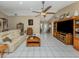 Open living room featuring tile flooring, comfortable sofa, and a media center at 2331 Mission Valley Blvd, Nokomis, FL 34275
