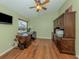 Home office with hardwood floors, a ceiling fan, and a wall of built in cabinets at 2331 Mission Valley Blvd, Nokomis, FL 34275