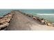 Scenic view of a pier stretching into the ocean, bordered by rocks and leading towards the horizon at 2331 Mission Valley Blvd, Nokomis, FL 34275