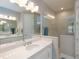 Luxurious bathroom features dual vanities, quartz countertops, and a modern glass-enclosed shower with stylish tile at 249 Tracino Ter, Nokomis, FL 34275