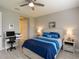 Serene bedroom with a desk area and tranquil blue bedding, complemented by soft lighting and neutral walls at 249 Tracino Ter, Nokomis, FL 34275