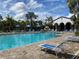 Resort-style community pool with ample lounge chairs and umbrellas at 249 Tracino Ter, Nokomis, FL 34275