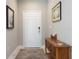 Inviting foyer featuring neutral walls, artwork, a wooden console table, and a decorative rug at 249 Tracino Ter, Nokomis, FL 34275
