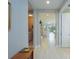 Bright hallway showcasing neutral walls, wood-look tile floors, and an open view into the living area and laundry room at 249 Tracino Ter, Nokomis, FL 34275